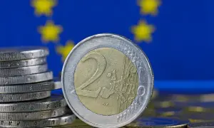 Monety euro na tle flagi UE. Tak, w Estonii jest euro, to waluta obowiązująca od 2011 roku.