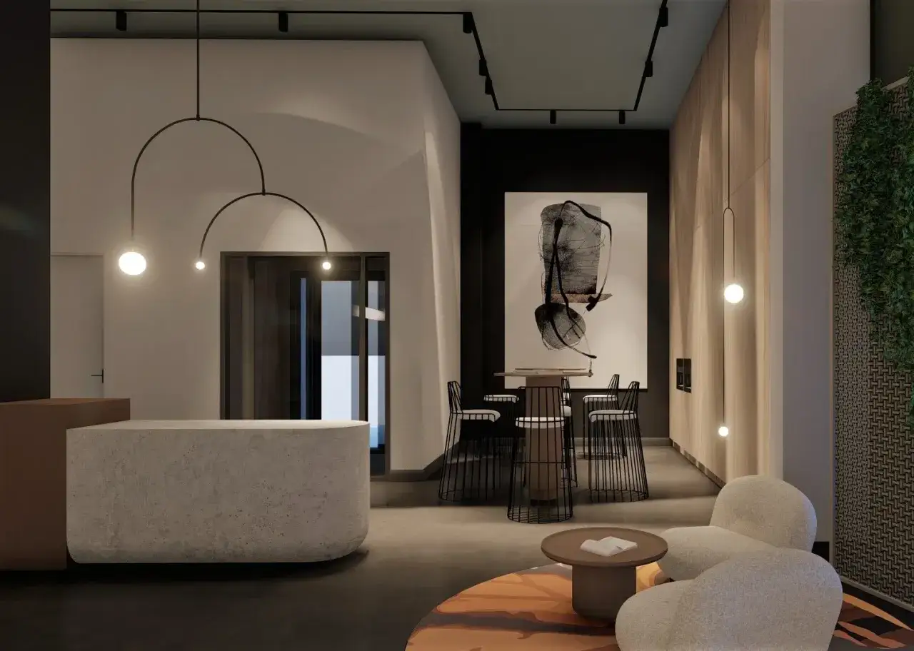 Nowoczesne lobby z betonową recepcją, designerskimi lampami, abstrakcyjnym obrazem i wygodnymi fotelami.