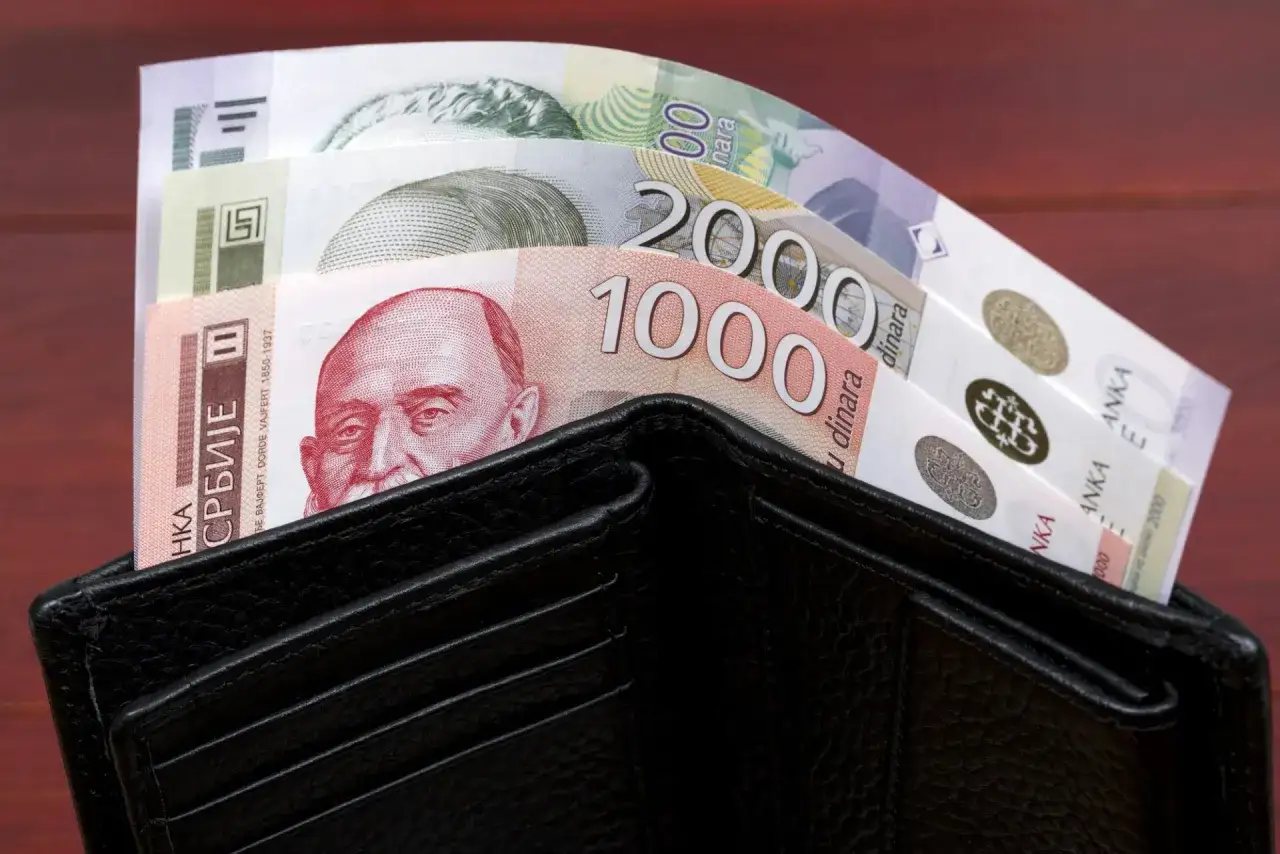 Czarna portmonetka z serbskimi dinarami. Widoczne nominały 1000 i 2000 dinarów. Co to za waluta RS?