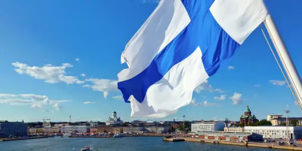 Flaga Finlandii powiewa nad portem w Helsinkach. W tle widać katedrę. Finlandia używa euro, więc to jest waluta, jaką ma Finlandia.